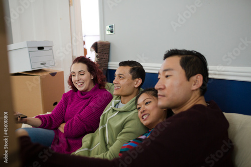 Happy friends taking a break from moving, taking selfie on sofa