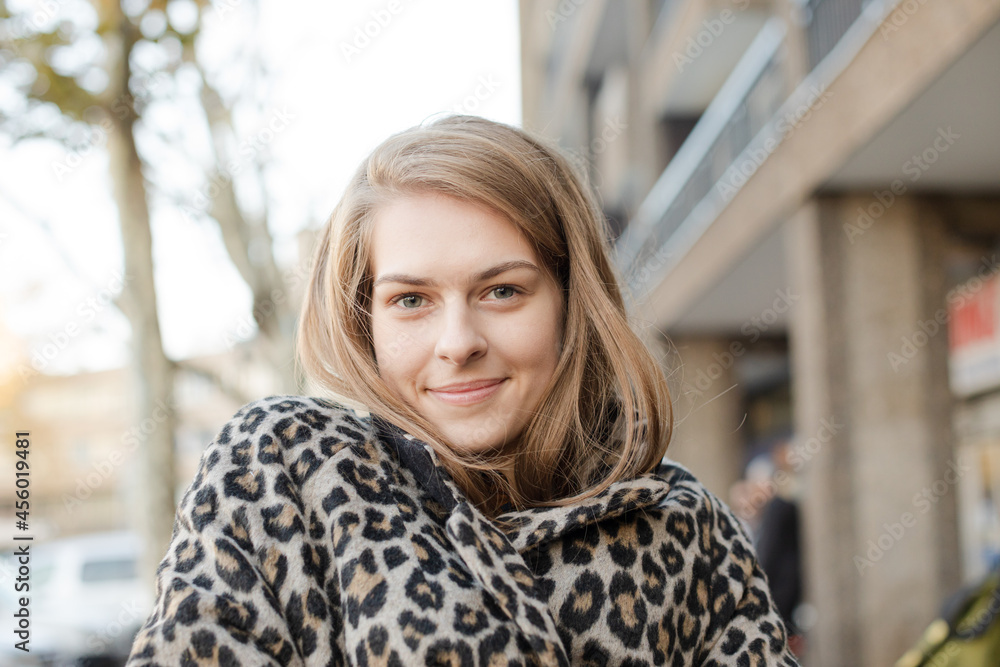 Portrait confident young woman in leopard print coat Portrait confident young woman in leopard print coat