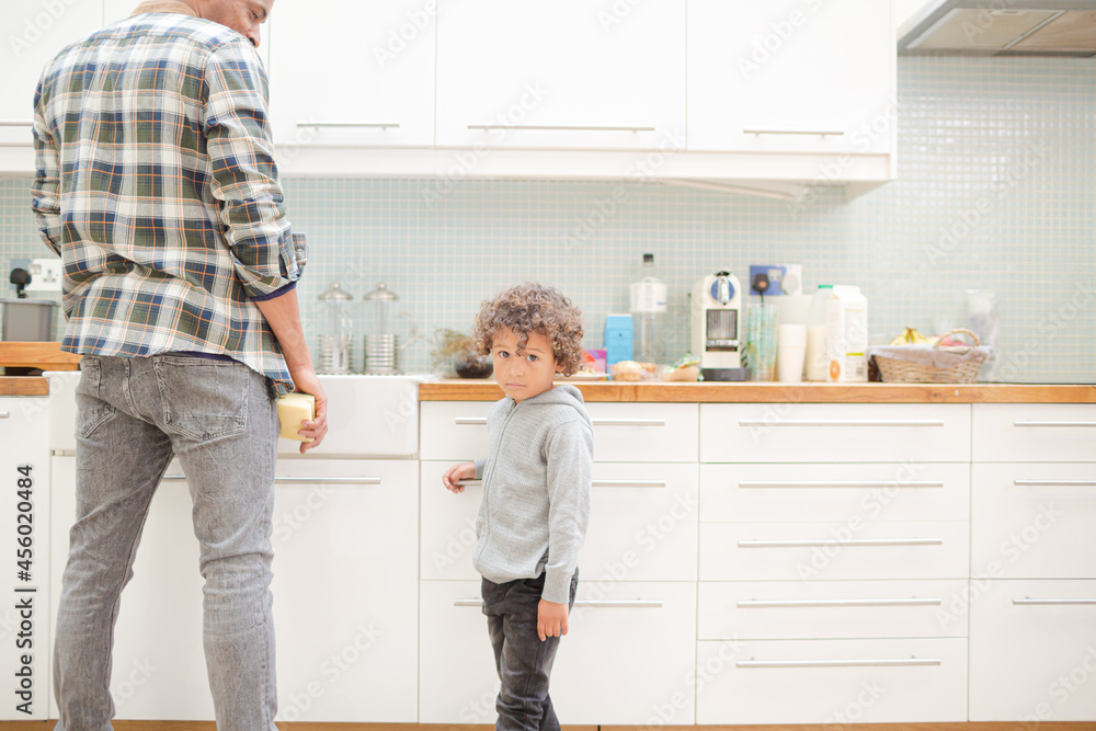 Father and son standing in kitchen Father and son standing in kitchen