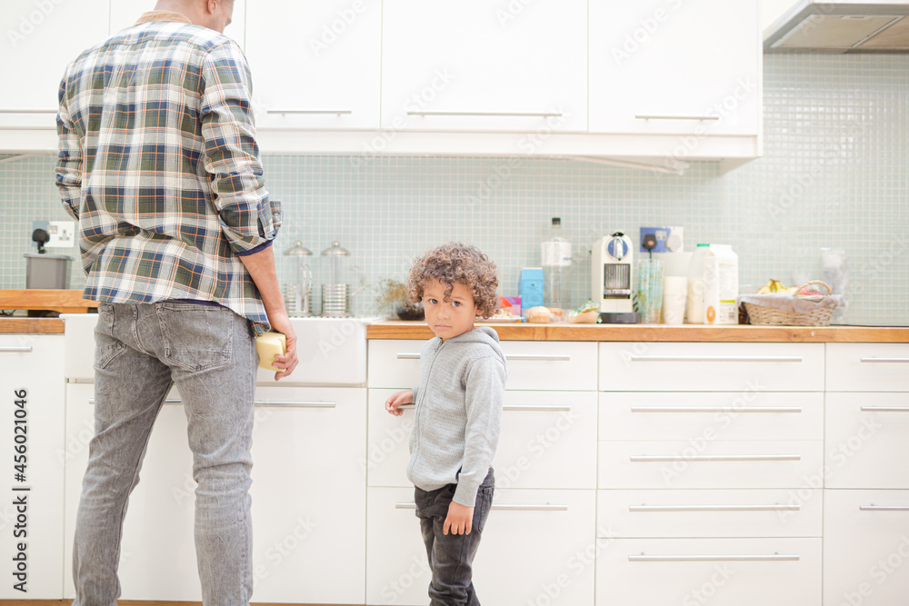 Father and son standing in kitchen Father and son standing in kitchen