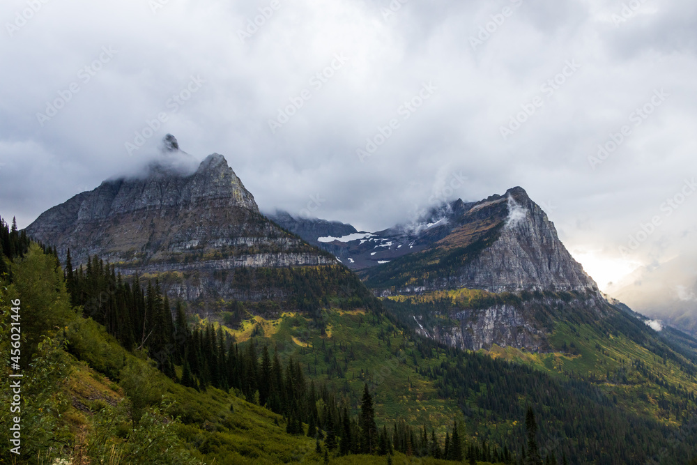 Obraz premium Storm clouds over mountains and valley in Glacier National Park, Montana, USA
