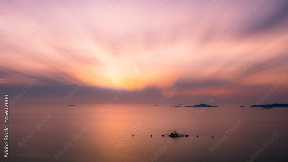 seascape nature scenes and motion blur process at twilight and small oil tank terminal in middle sea for background wallpaper concept photograph aerial view from drone