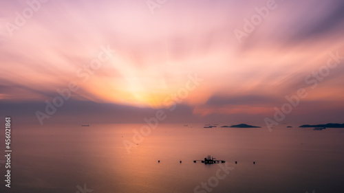 seascape nature scenes and motion blur process at twilight and small oil tank terminal in middle sea for background wallpaper concept photograph aerial view from drone © SHUTTER DIN