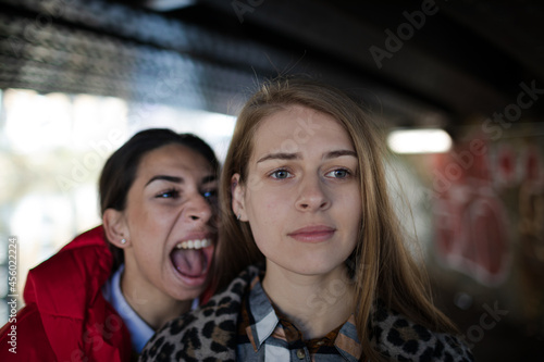 Angry young woman yelling at friend © KOTO