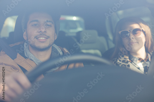 Happy young couple wearing sunglasses in car © KOTO