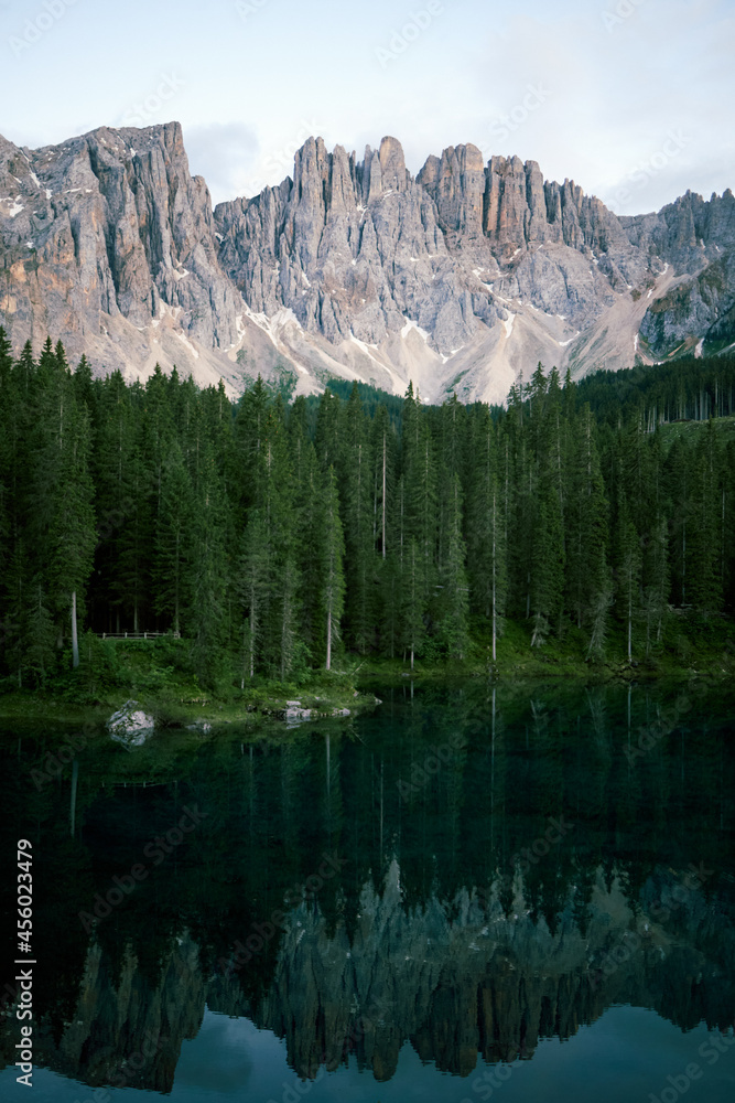 Crystal water of Lake Carezza (Karersee) in Dolomite Alps, Trentino Alto Adige, South Tirol, Italy at daytime