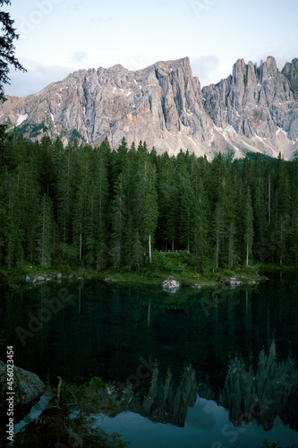 Crystal water of Lake Carezza (Karersee) in Dolomite Alps, Trentino Alto Adige, South Tirol, Italy at daytime