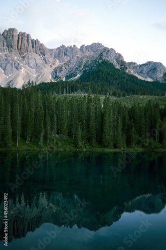 Crystal water of Lake Carezza (Karersee) in Dolomite Alps, Trentino Alto Adige, South Tirol, Italy at daytime © Роман Мельник