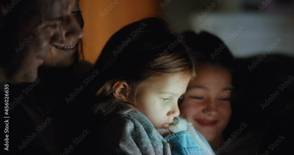 family using tablet computer little girl watching entertainment with mother and father on touchscreen technology enjoying relaxing before bedtime 4k family using tablet computer little girl watching entertainment with mother and father on touchscreen technology enjoying relaxing before bedtime 4k