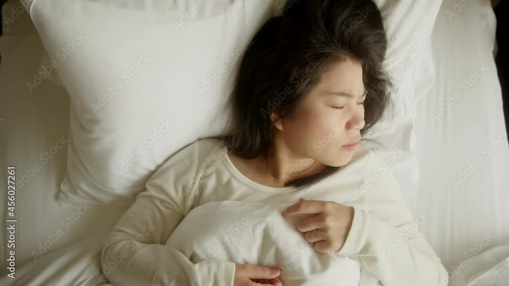 worry unhappy asian female woman feeling trouble and confused so many thing in the head and cannot sleep ,sleepless asian female woman closeup on the bed at home worry unhappy asian female woman feeling trouble and confused so many thing in the head and cannot sleep ,sleepless asian female woman closeup on the bed at home