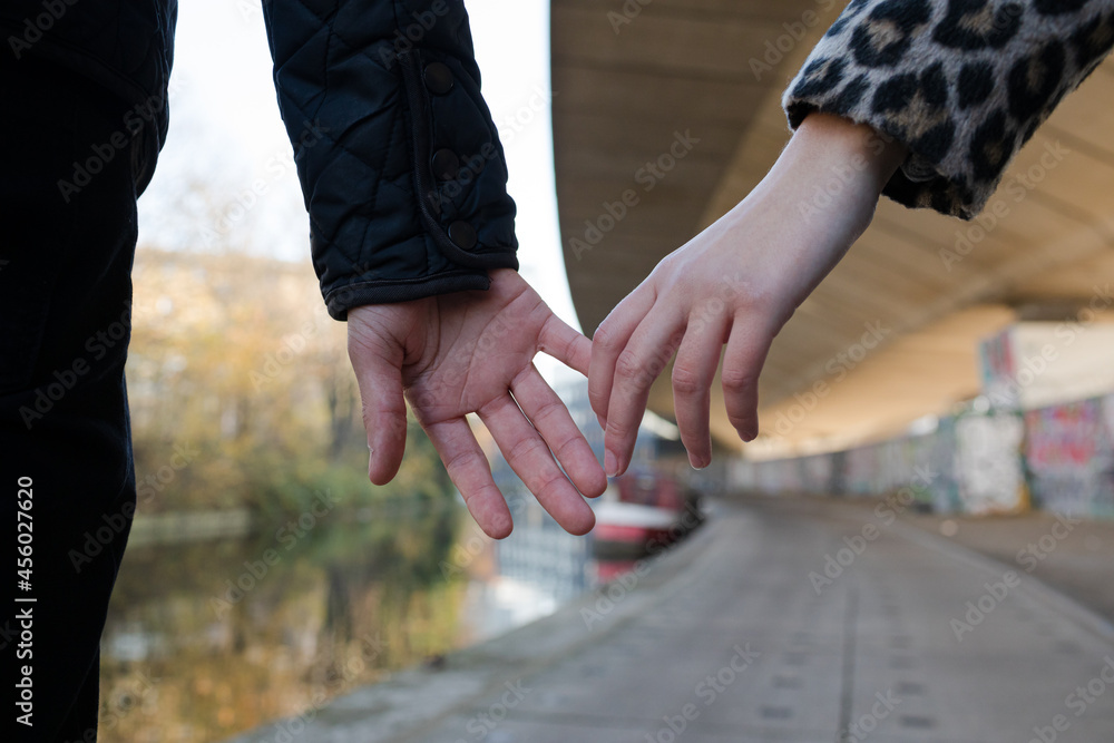 Close up affectionate young couple holding hands