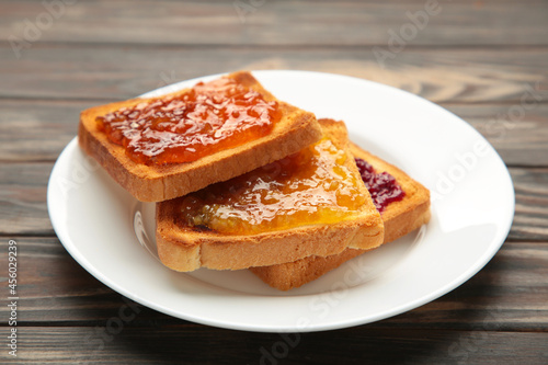 Fresh toast with butter and different jams on table