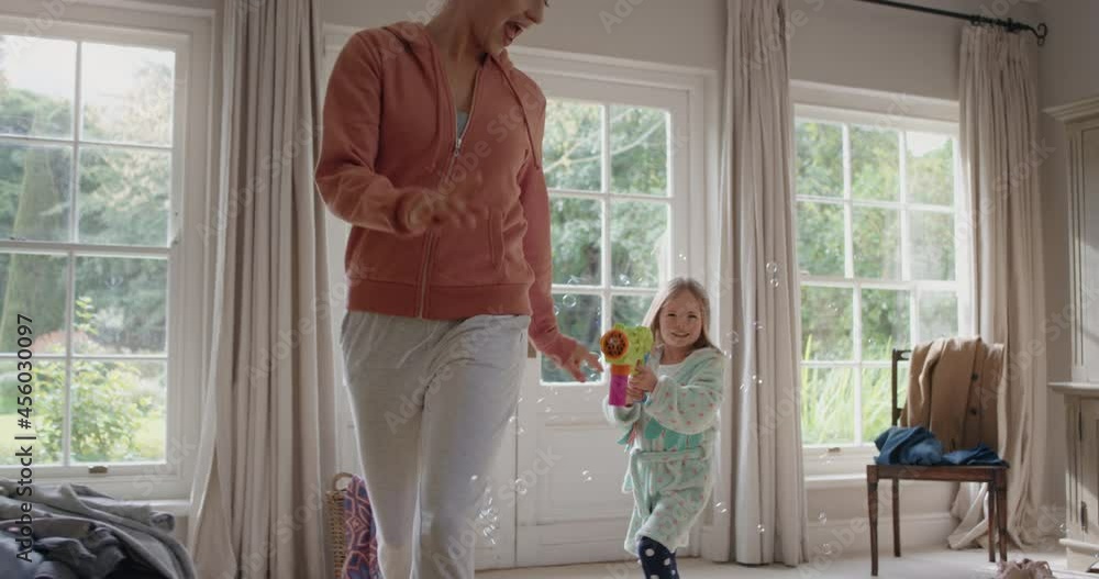 playful little girl blowing bubbles chasing mother with toy gun running through house playing catch happy mom enjoying fun game with daughter enjoying weekend morning 4k footage playful little girl blowing bubbles chasing mother with toy gun running through house playing catch happy mom enjoying fun game with daughter enjoying weekend morning 4k footage