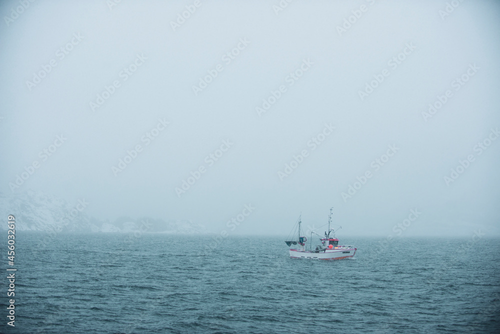 fishing boat in foggy ocean in northern norway fishing boat in foggy ocean in northern norway