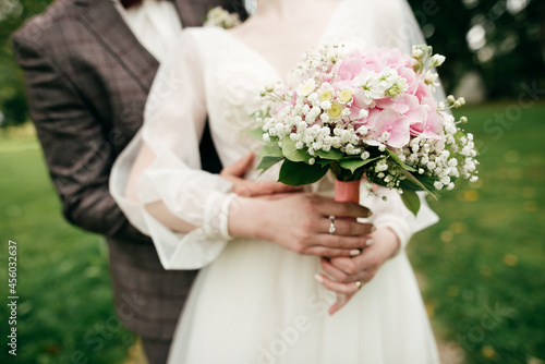 Bride holding her bouquet with pink hydrangea