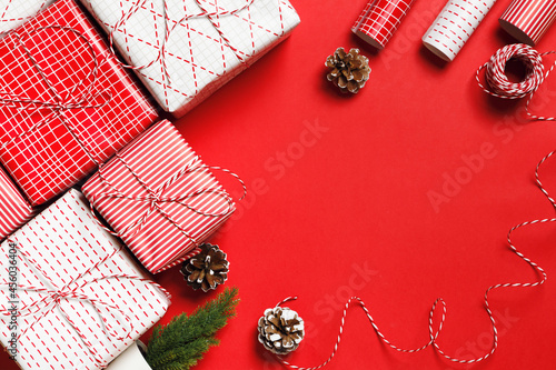 Christmas gifts on a red background with place for text. Celebration and present wrapping.