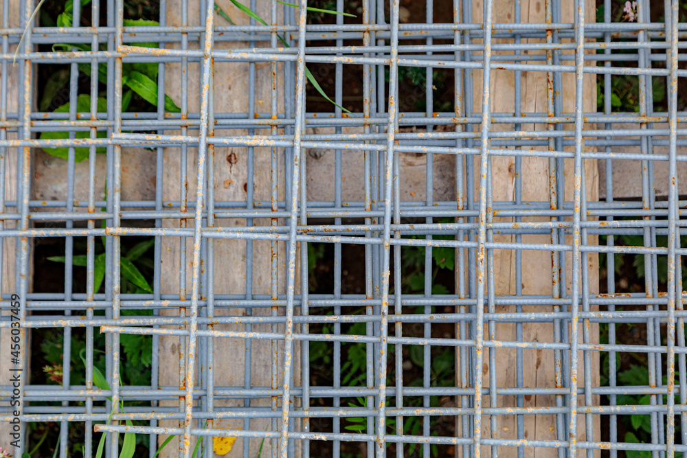 Steel wire mesh used in construction. A metal mesh lies on a wooden pallet at a construction site. Steel wire mesh used in construction. A metal mesh lies on a wooden pallet at a construction site.