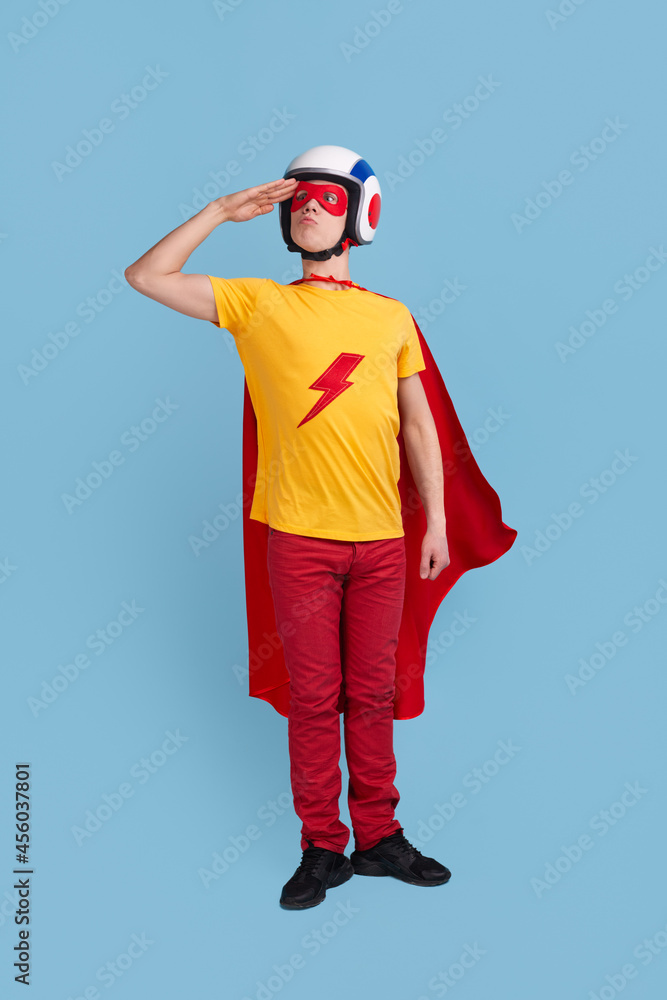 Funny superhero in helmet saluting Funny superhero in helmet saluting