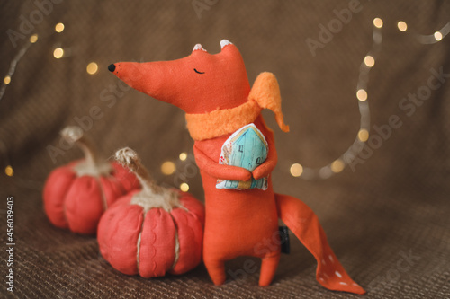 cozy autumn composition with a funny handmade toy fox, fall home decoration