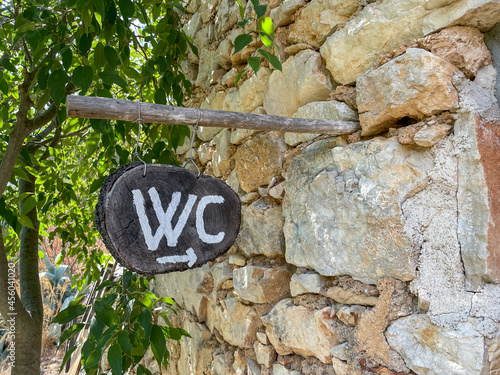 Sign pointing out the location of a restroom at a small restaurant in Malo Grablje village, Hvar, Croatia. photo