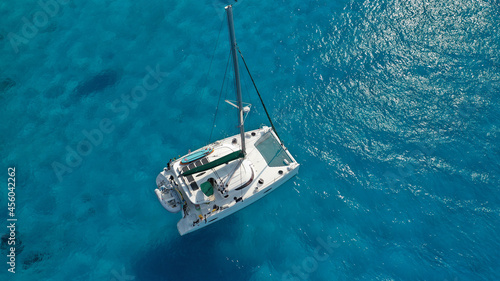 Fotografering Aerial drone photo of beautiful catamaran sailing yacht anchored in tropical exo