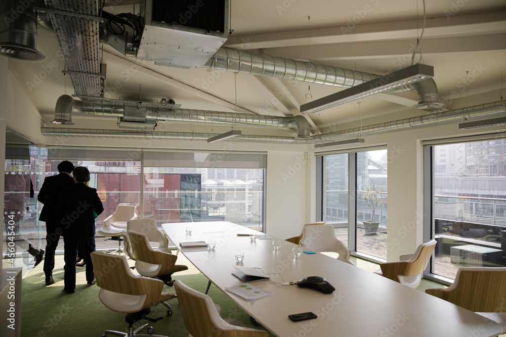 Business people leaving conference room after meeting Business people leaving conference room after meeting
