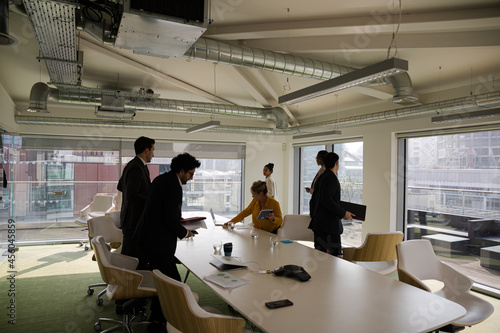 Business people leaving conference room after meeting