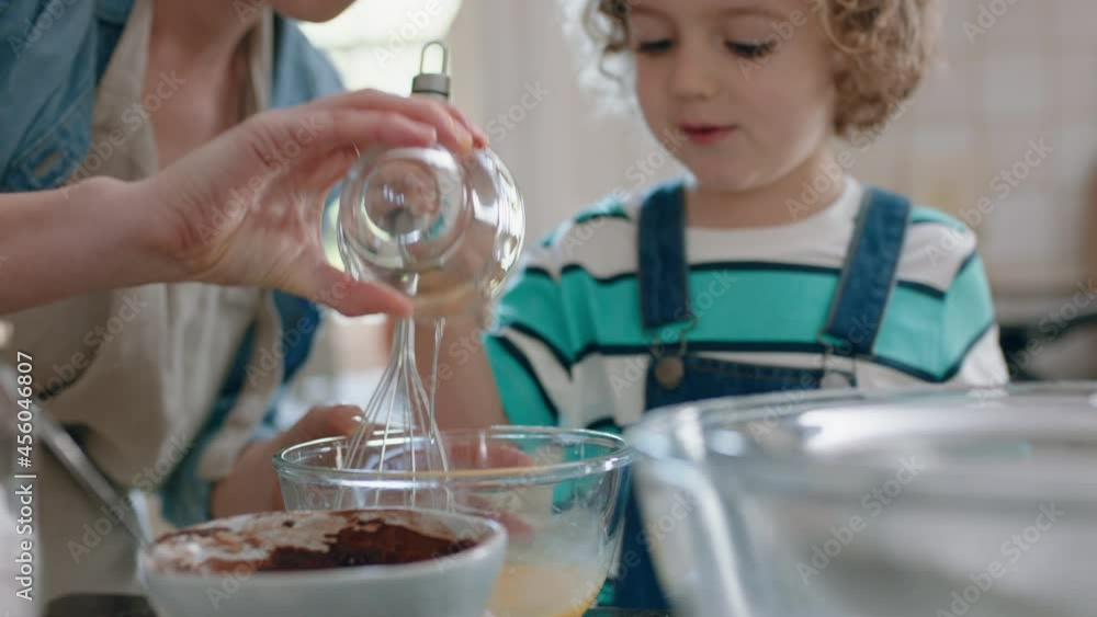 little boy helping mother bake in kitchen mixing ingredients baking chocolate cupcakes preparing recipe at home little boy helping mother bake in kitchen mixing ingredients baking chocolate cupcakes preparing recipe at home