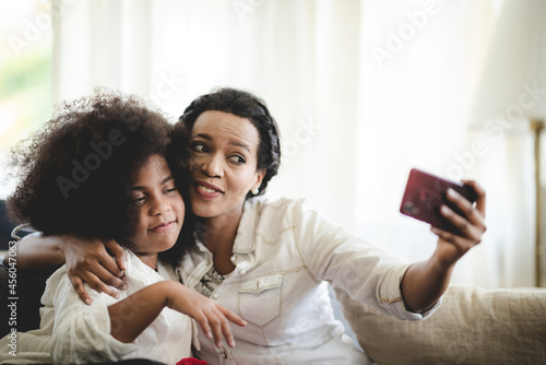 Cheerful young mother takin...