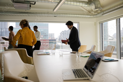 Business people leaving conference room after meeting