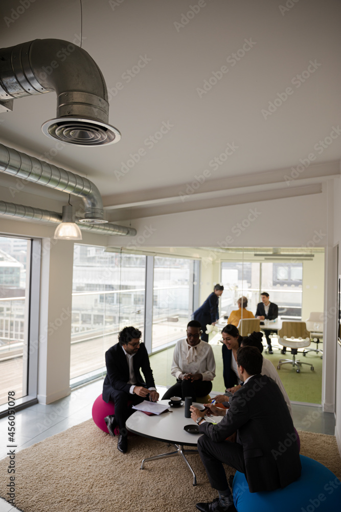 Business people discussing paperwork in relax zone