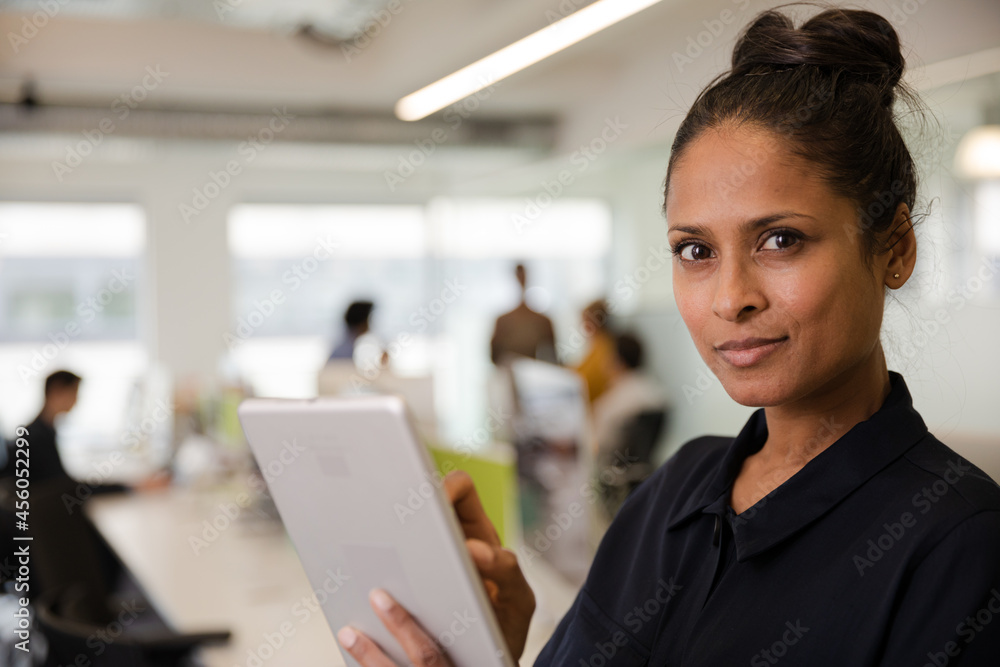 Portrait of confident businesswoman in open plan office Portrait of confident businesswoman in open plan office