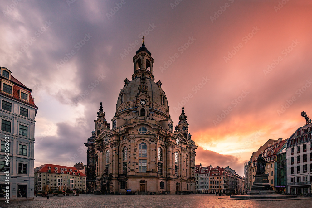 Dresden sunrise in the city on a market square. The Frauenkiche as a symbol of Dresden in a unique light. Historical market square with one of the sights of Germany

