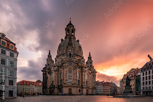 Dresden sunrise in the city on a market square. The Frauenkiche as a symbol of Dresden in a unique light. Historical market square with one of the sights of Germany