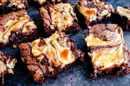 Brownies Topped with a Cream Cheese Swirl: Closeup view of freshly baked brownies swirled with cream cheese