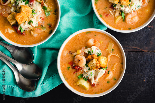 Bowls of Shrimp and Crab Bisque with Garnish: Seafood bisque topped with crab salad, croutons, and parsley photo