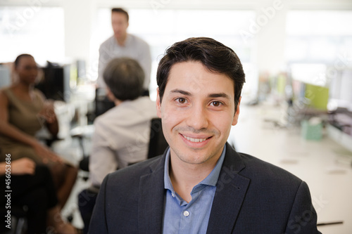Portrait of smiling businessman in conference room