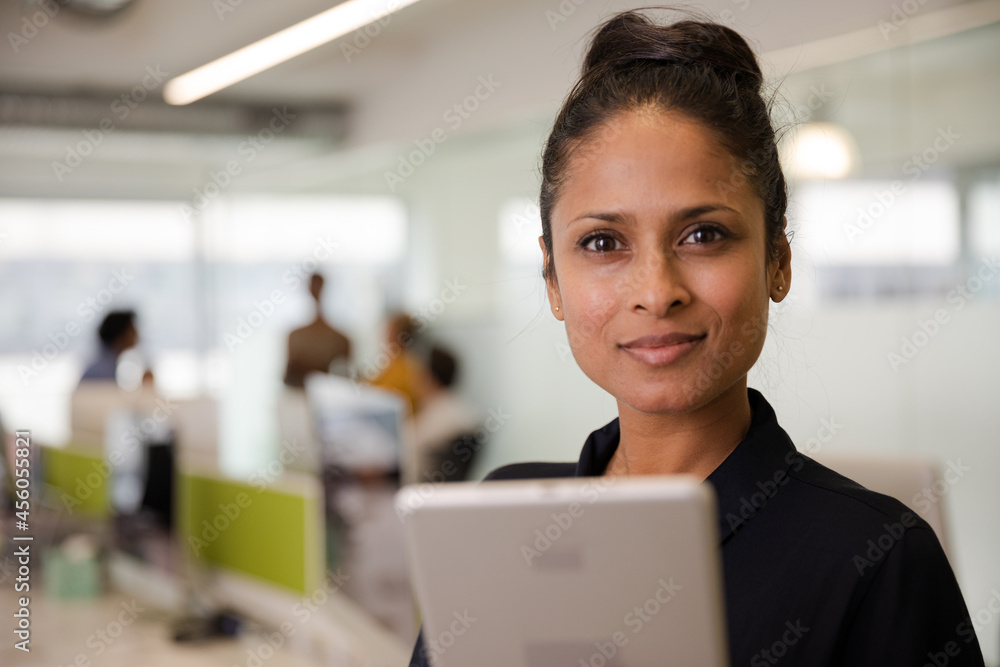 Portrait of confident businesswoman in open plan office Portrait of confident businesswoman in open plan office
