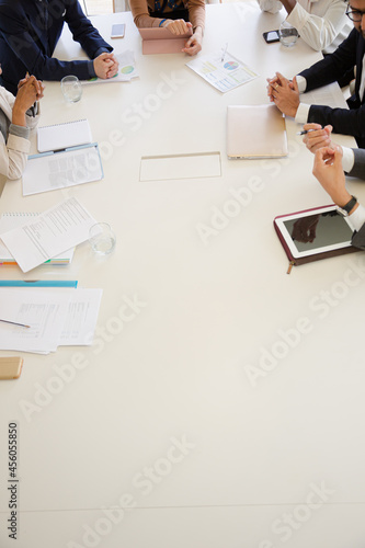 Paperwork and electronics on conference room table