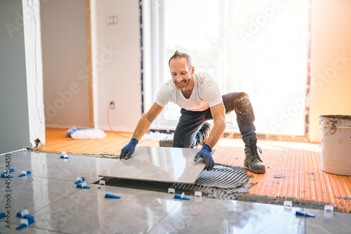 nice handyman install tile on the floor photo