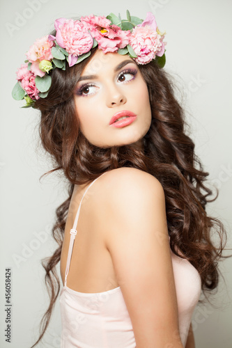 Beautiful model woman in flowers crown. Woman spring makeup portrait