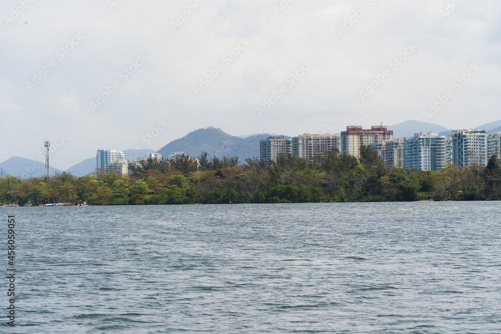 View of the Marapendi lagoon with buildings in the background and ferry boats waiting for passengers. Viewed from inside another boat on the lagoon. Located near Praia da Reserva in Rio de Janeiro