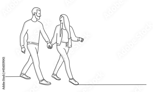 Man and woman walking together holding hands.