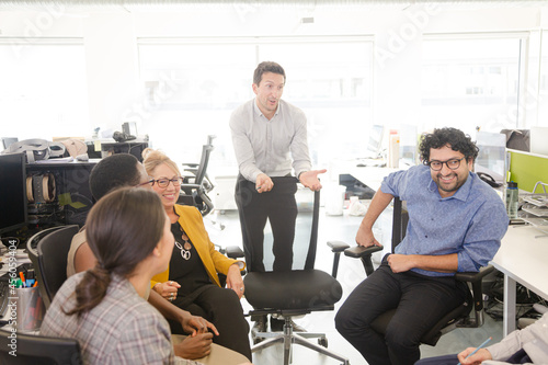 Business people meeting at computer in open plan office