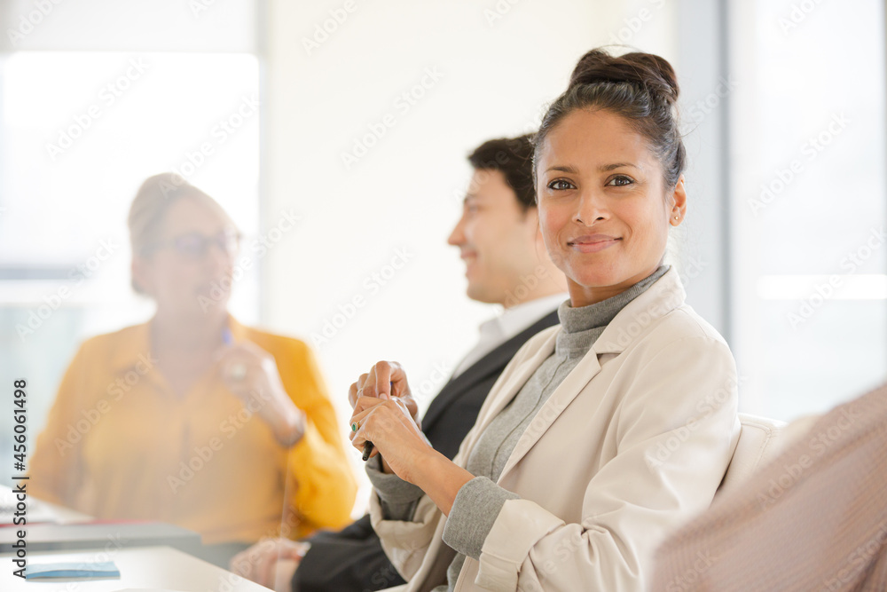 Fototapeta premium Portrait of smiling businesswoman in conference room meeting