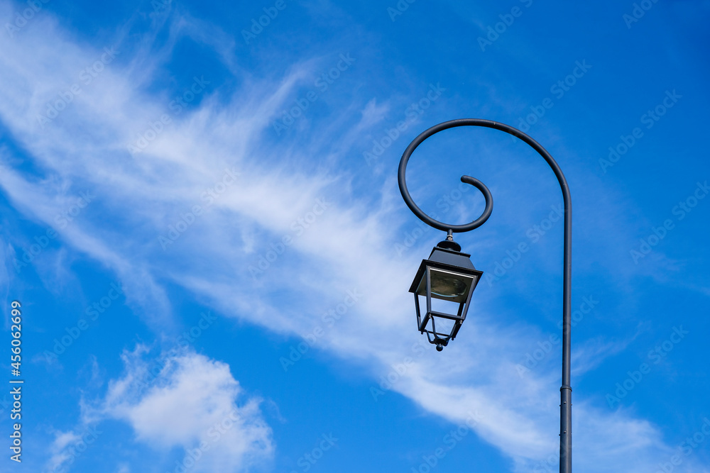 Lantern on a blue sky background. Feathery clouds. Copy space. Lantern on a blue sky background. Feathery clouds. Copy space.