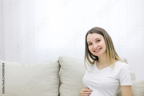 Cropped view of cute pregnant woman on white background.