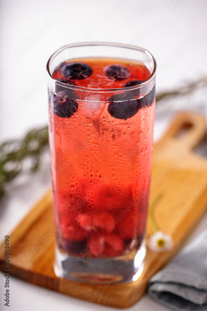 Tall glass with red fruits juice on ice Tall glass with red fruits juice on ice