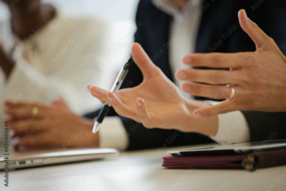 Business people taking notes during conference room meeting Business people taking notes during conference room meeting