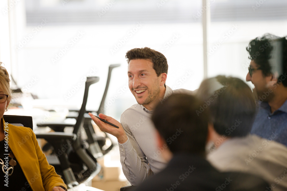 Business people brainstorming in open plan office Business people brainstorming in open plan office